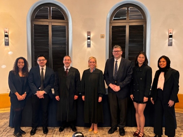 Image of Brittney Ortiz with ABA Moot Court judges and competitors