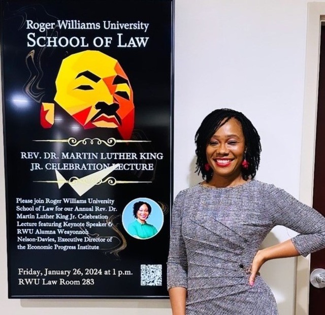 Nelson-Davies posing beside the RWU Law Martin Luther King poster in Jan 2024