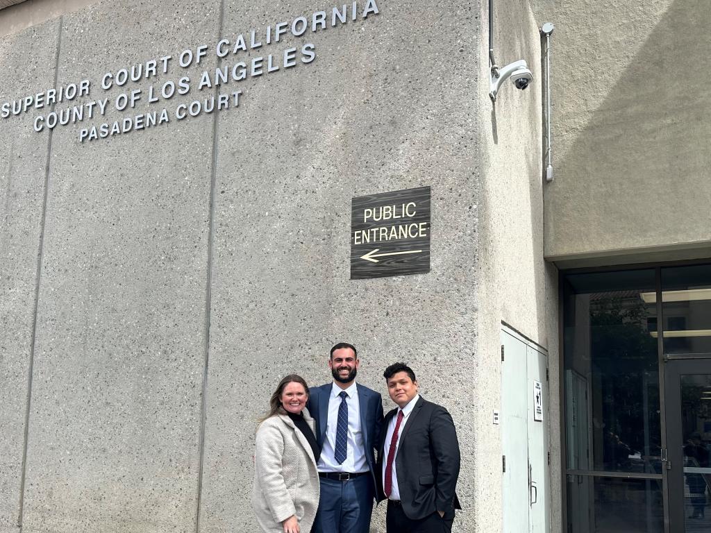 Zaki Farah flanked by two other RWU Law studnets with the LA Superior Court of California building behind them.