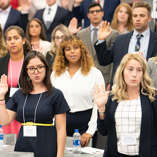Students raising hands in classroom