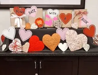 Knitted hearts and books wrapped in paper.