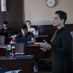 A professor speaks to a class of students