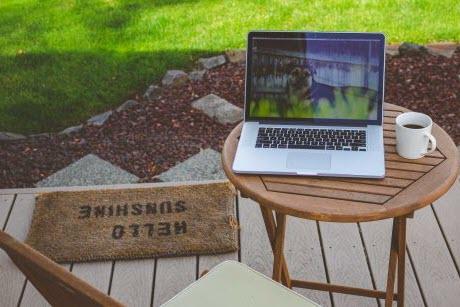 Chair and small table on laptop located on a patio