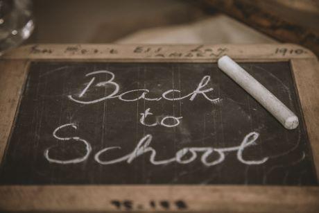 "Back to School" written in chalk on a hand held chalkboard