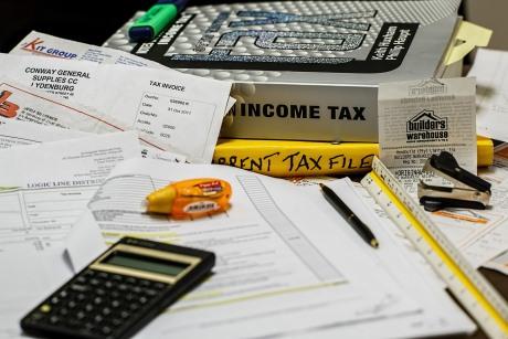 Income tax book, papers, and calculator