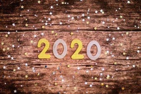  Photograph of the number 2020 with star confetti on a wooden background 