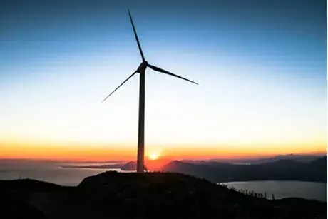 Wind turbine in front of a sunrise