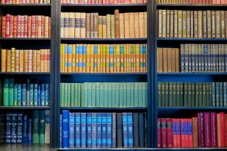 colorful books on book shelves.