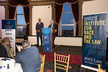 School of Law Dean Gregory W. Bowman speaks at a podium at the Champions for Justice event