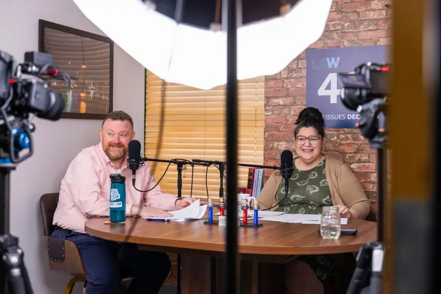 Hosts Nicole and Michael behind the mic of the podcast