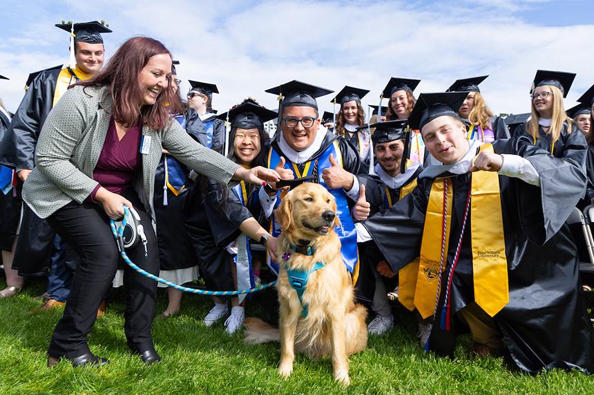 Graduates pose with Roger the dog