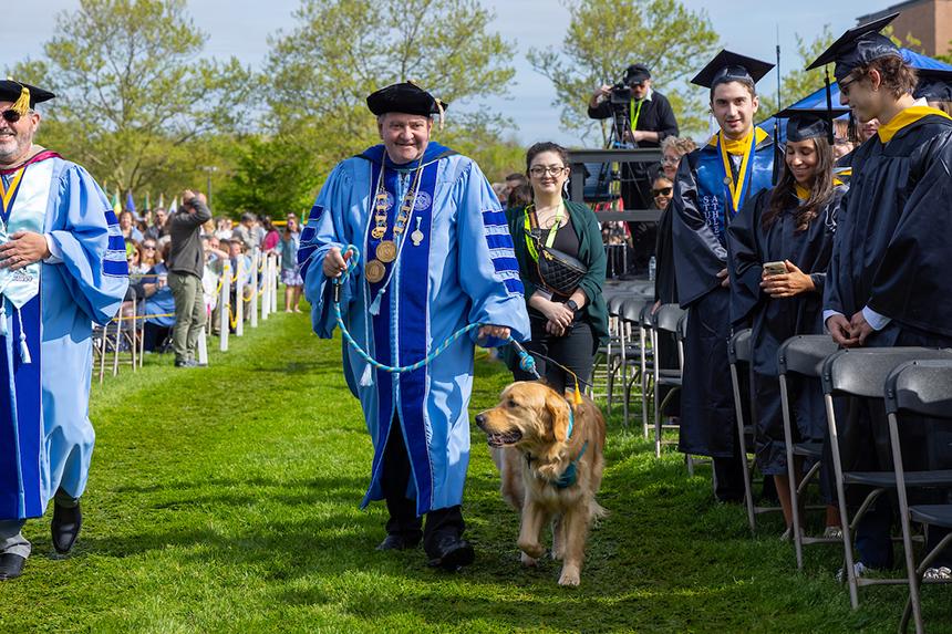 President Miaoulis processes in with his dog