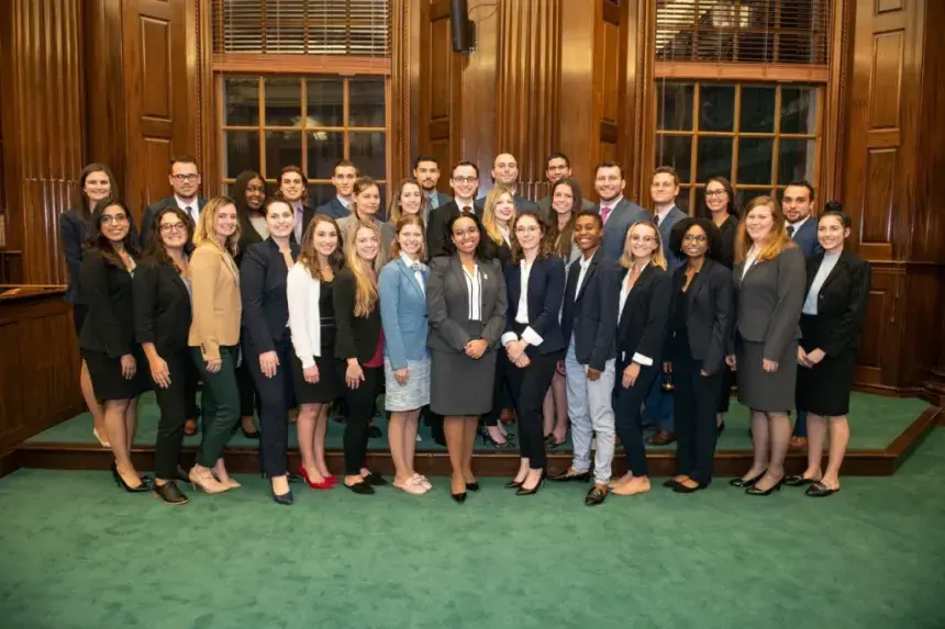 Photo of the Moot Court Board and the competitors.